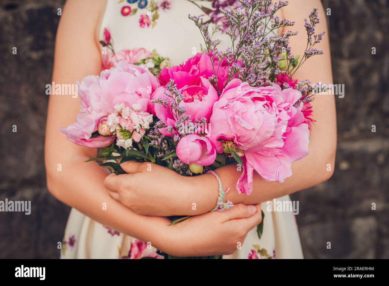 Close up image of beautiful peonies bouquet holding by young girl Stock ...