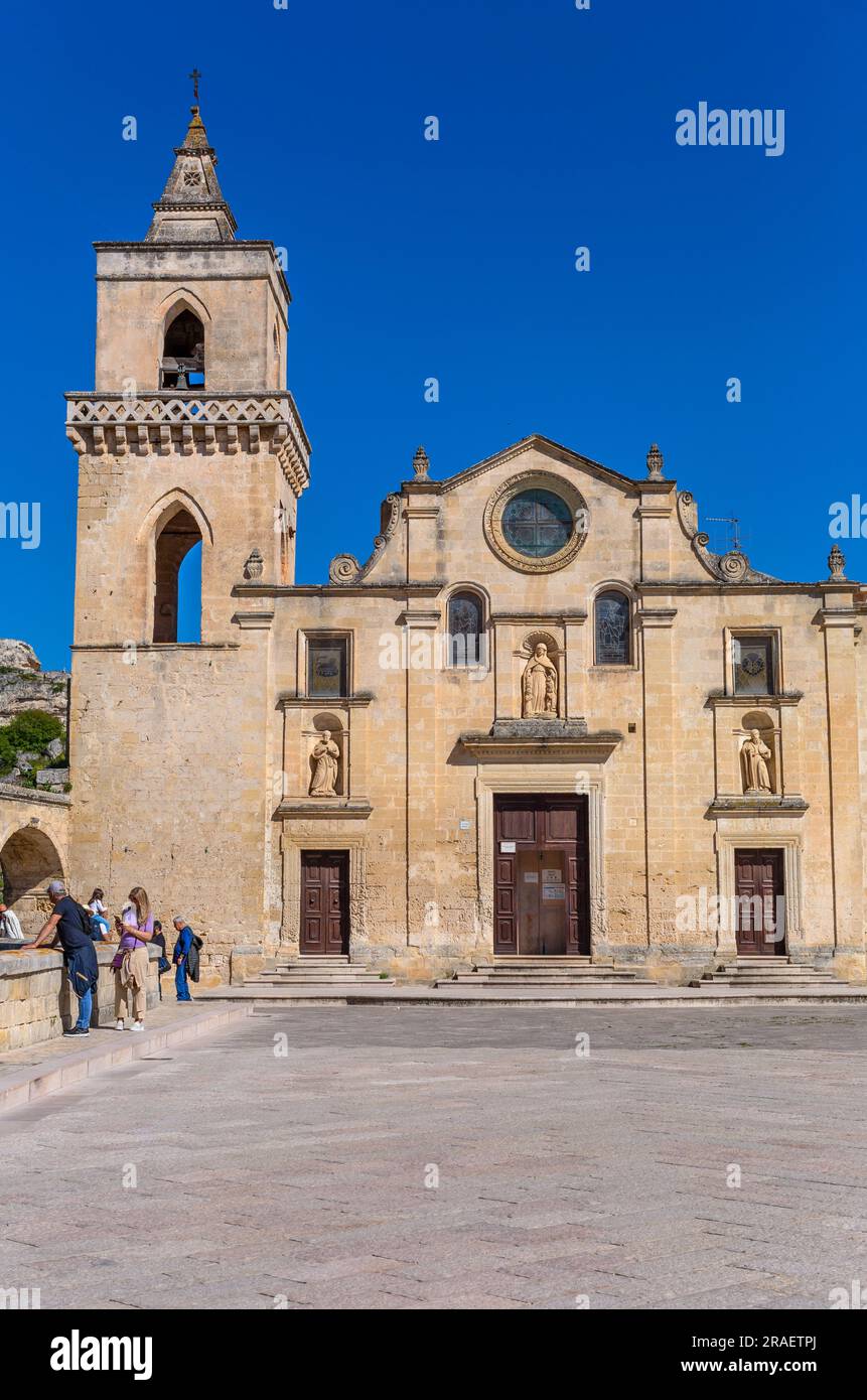 Matera, Italy - 6 May 2023: Tourists enjoy a summer day on the piazza of the Church of San Pietro Caveoso Stock Photo