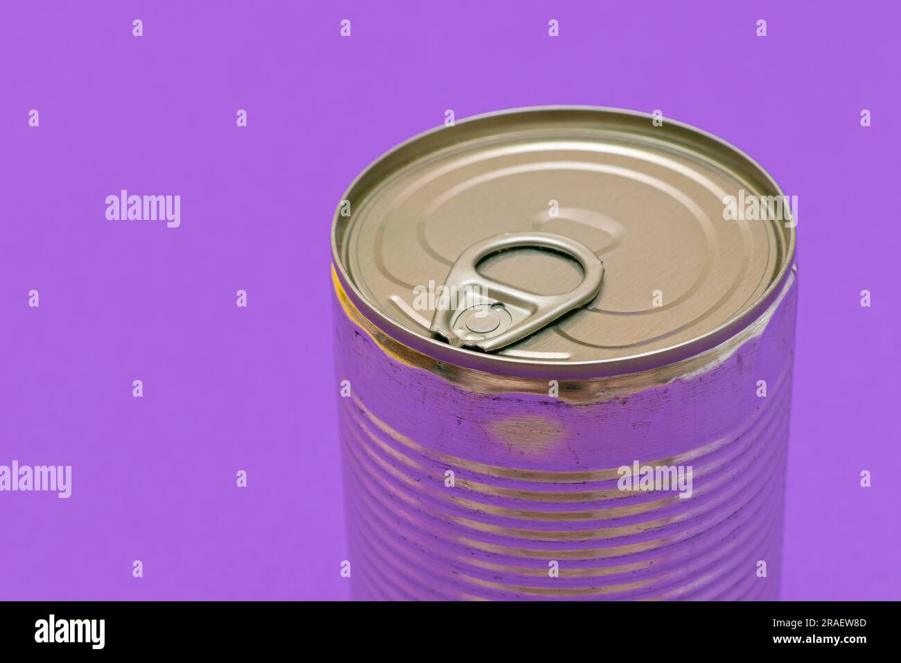 Unopened Tin Can with Blank Edge on Violet Background. Canned Food