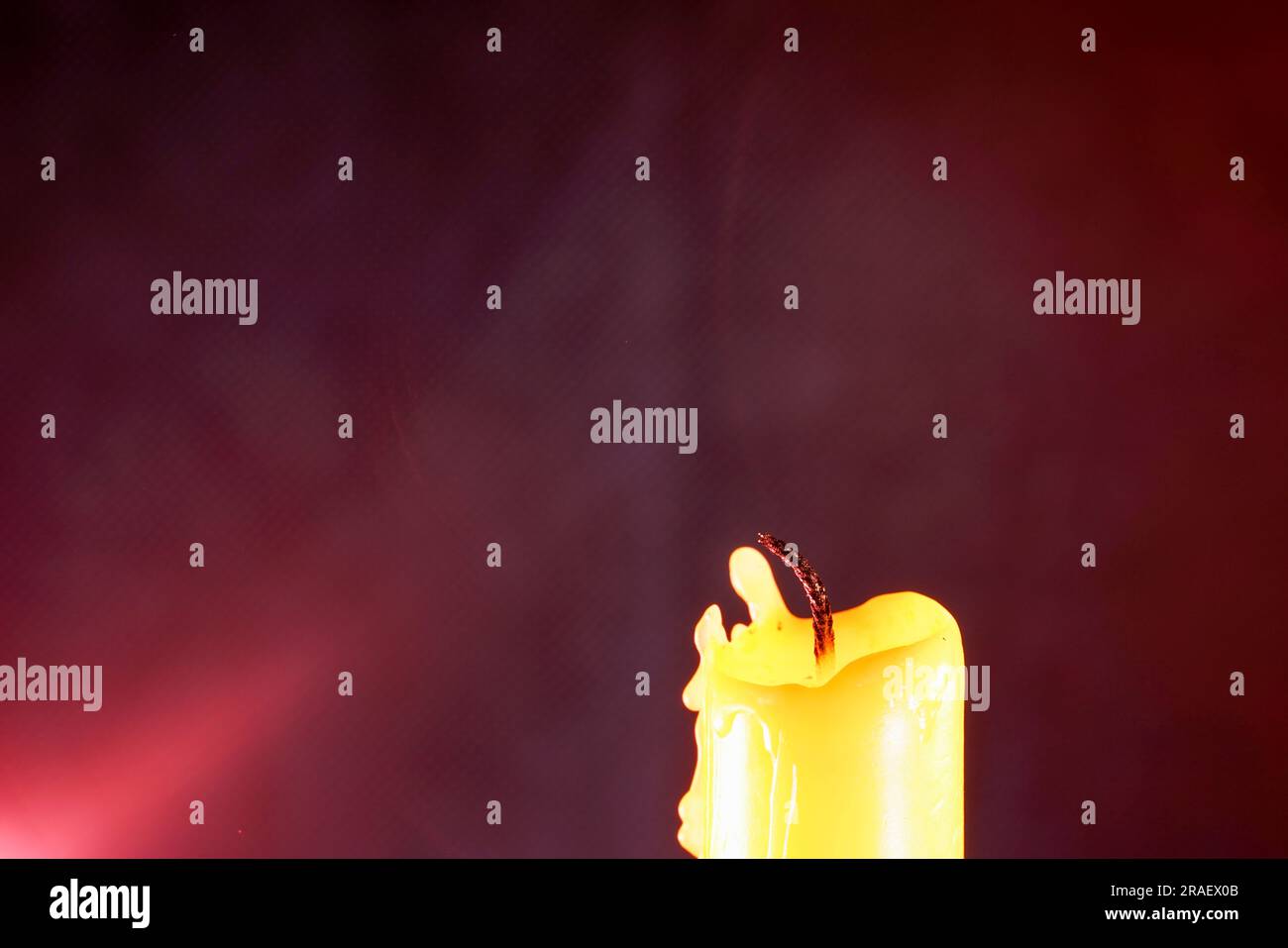 candle with smoke and flame photographed in the studio with color foils