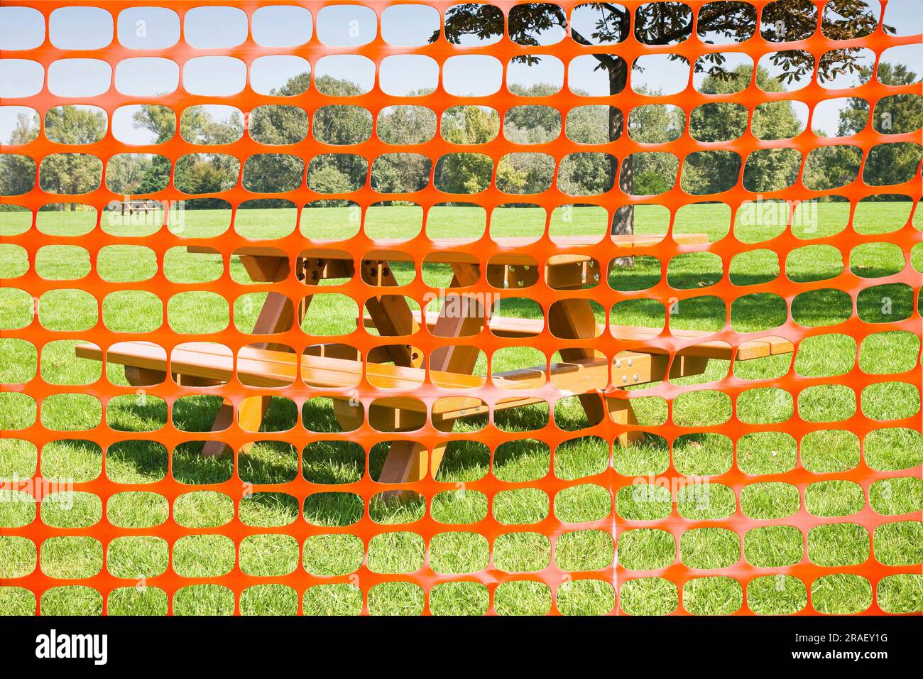 Closed picnic area with safety plastic orange grid against wooden