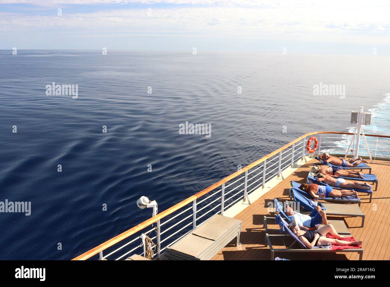 Cruise guests aboard the P&O cruise ship Arcadia soak up the Mediterranean sun topping up their tan en-route to Alicante, Spain, April 2023. Stock Photo