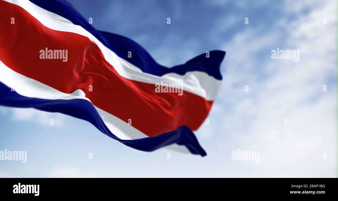 Costa Rica national civil flag waving in the wind on a clear day. Blue, white, red, white, blue