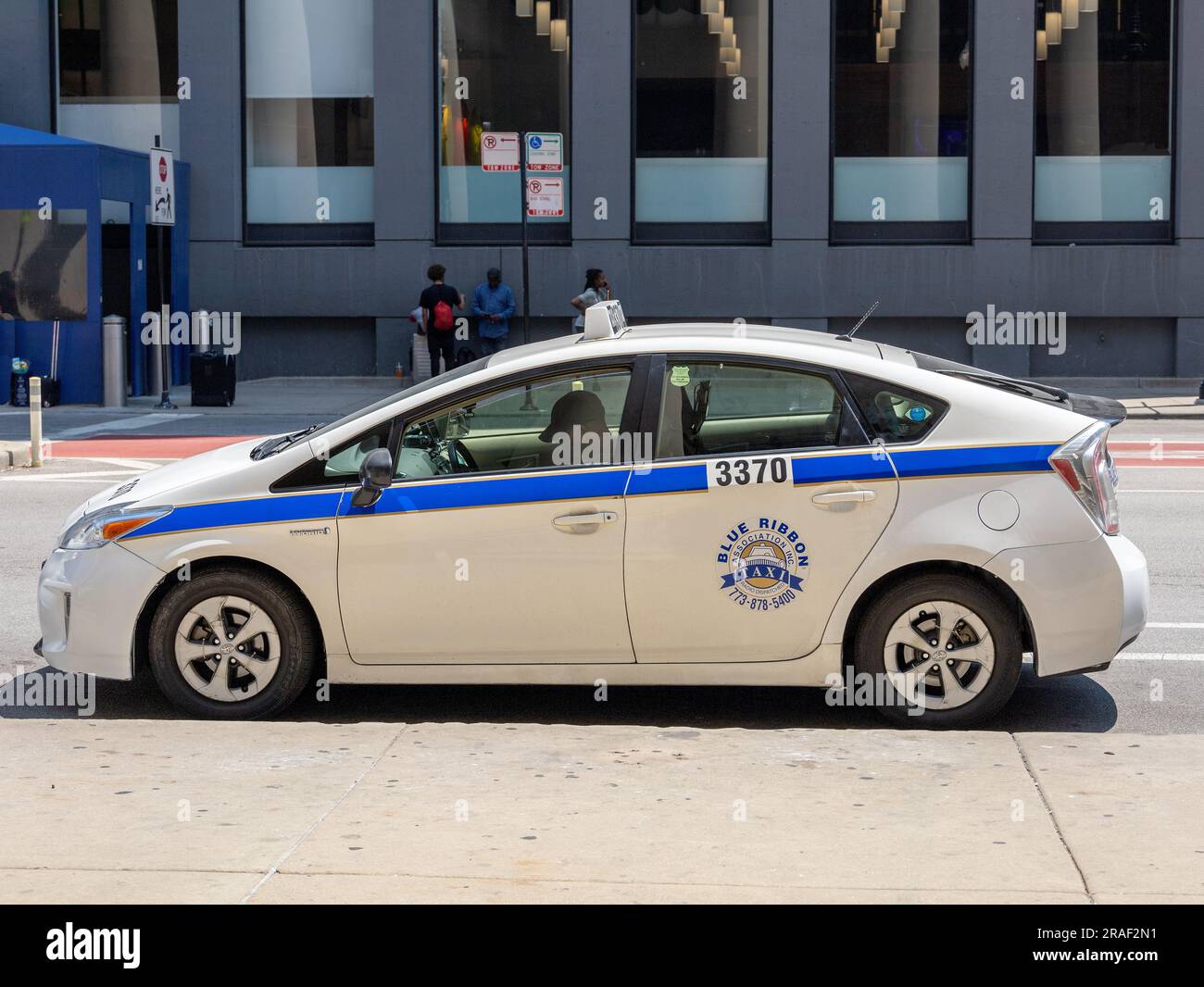 Blue Ribbon Chicago Prius Taxi Cab Parked On A City Street Waiting For Clients Chicago Downtown. Stock Photo