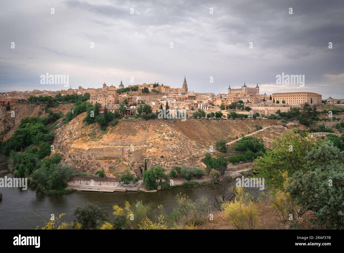 Toledo city, view in dramatic light of the historic city of Toledo sited on a hill above the Tagus River, Central Spain Stock Photo