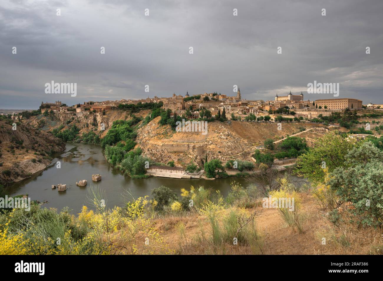 Toledo Spain, view in dramatic light of the historic city of Toledo famously sited on a hill above a bend in the Tagus River, Central Spain Stock Photo