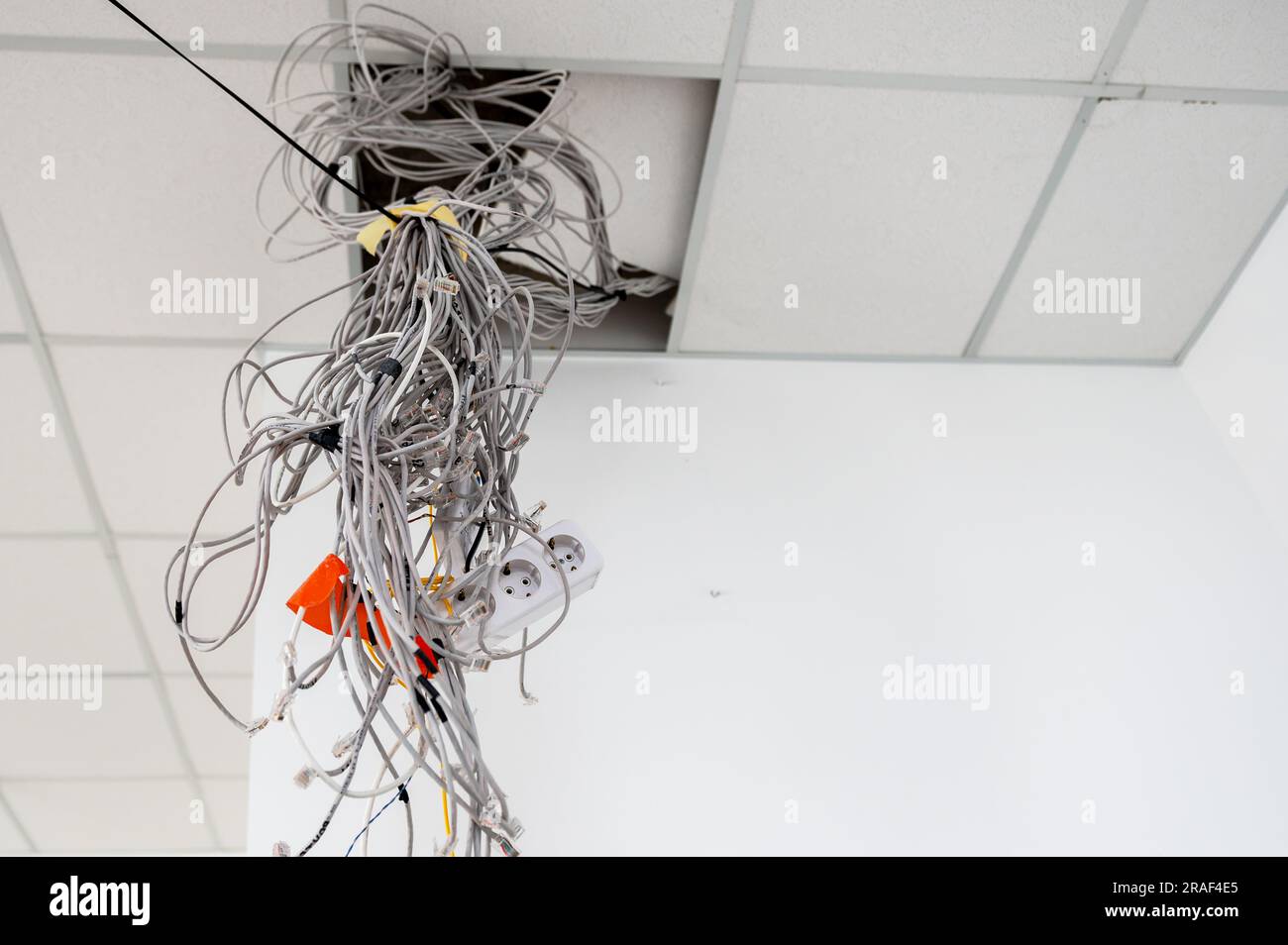 Electrical wires hanging from the ceiling. Cables hanging from ceiling