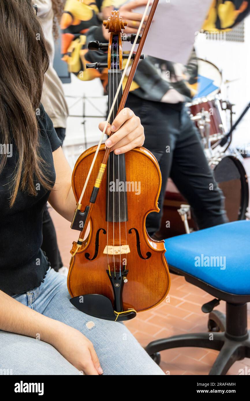 Real life young music students during rehearsals. Musical instruments