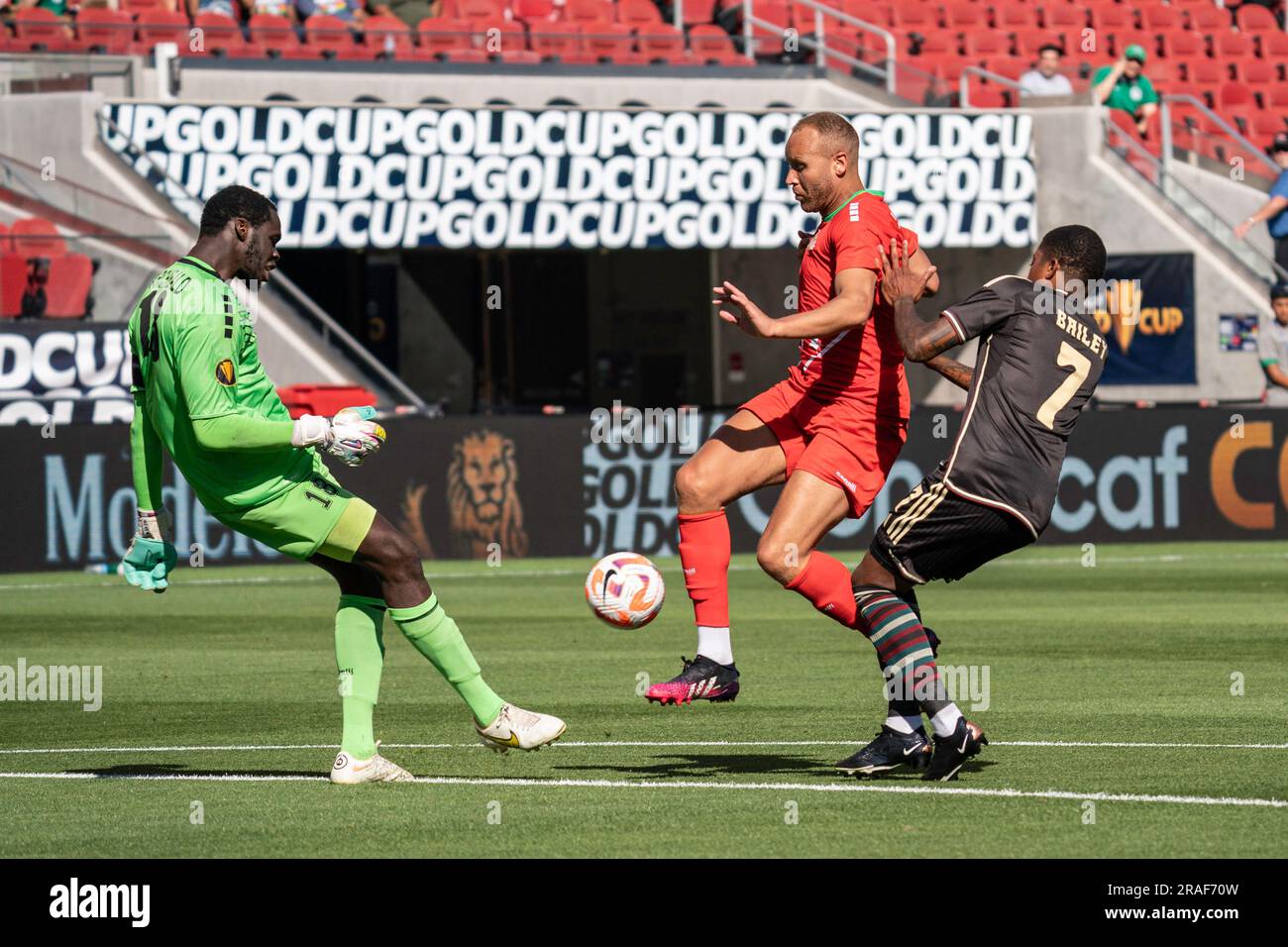 Saint Kitts and Nevis goalkeeper Julani Archibald (18) clears a ball intended for Jamaica forward Leon Bailey (7) during a Gold Cup match, Sunday, Jul Stock Photo