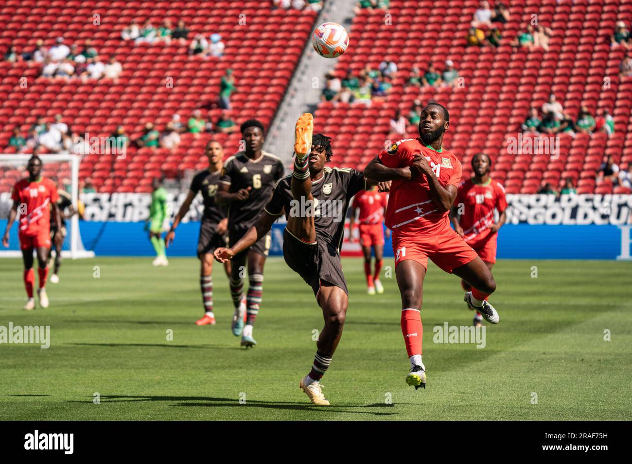 Jamaica defender Dexter Lembikisa (2) clears the ball against Saint Kitts and Nevis forward Omari Sterling-James (21) during a Gold Cup match, Sunday, Stock Photo