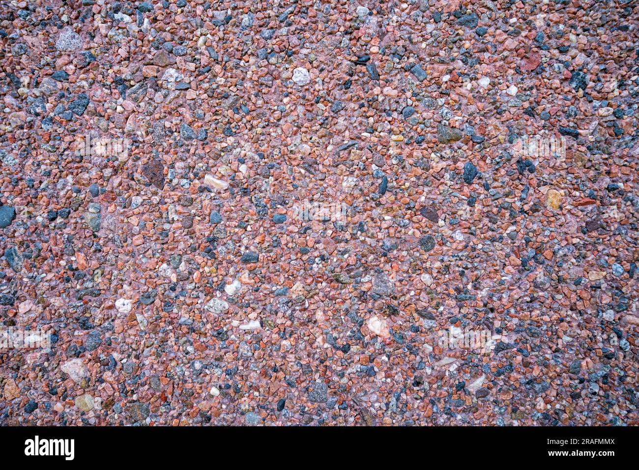 Background of small tiny colored pebbles. Background of pebbles of different shapes and colors. Stock Photo