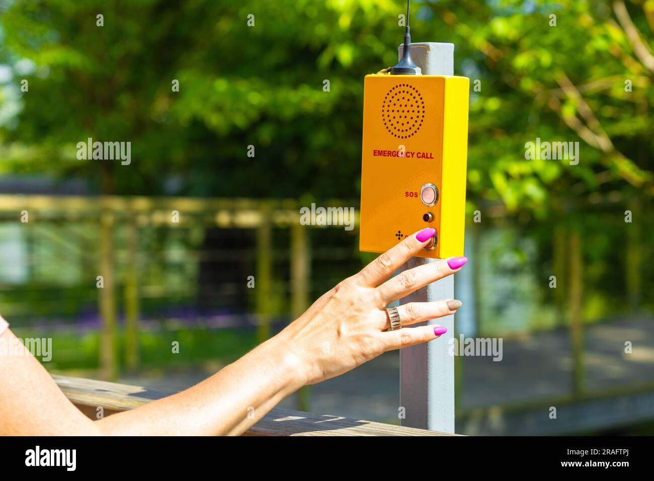 woman calling rescuers by walkie-talkie in the park. park help signal ...