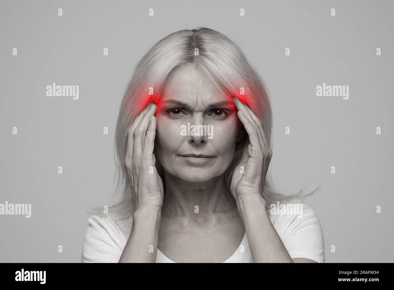 Migraine Concept. Mature woman with headache touching red sore zones on