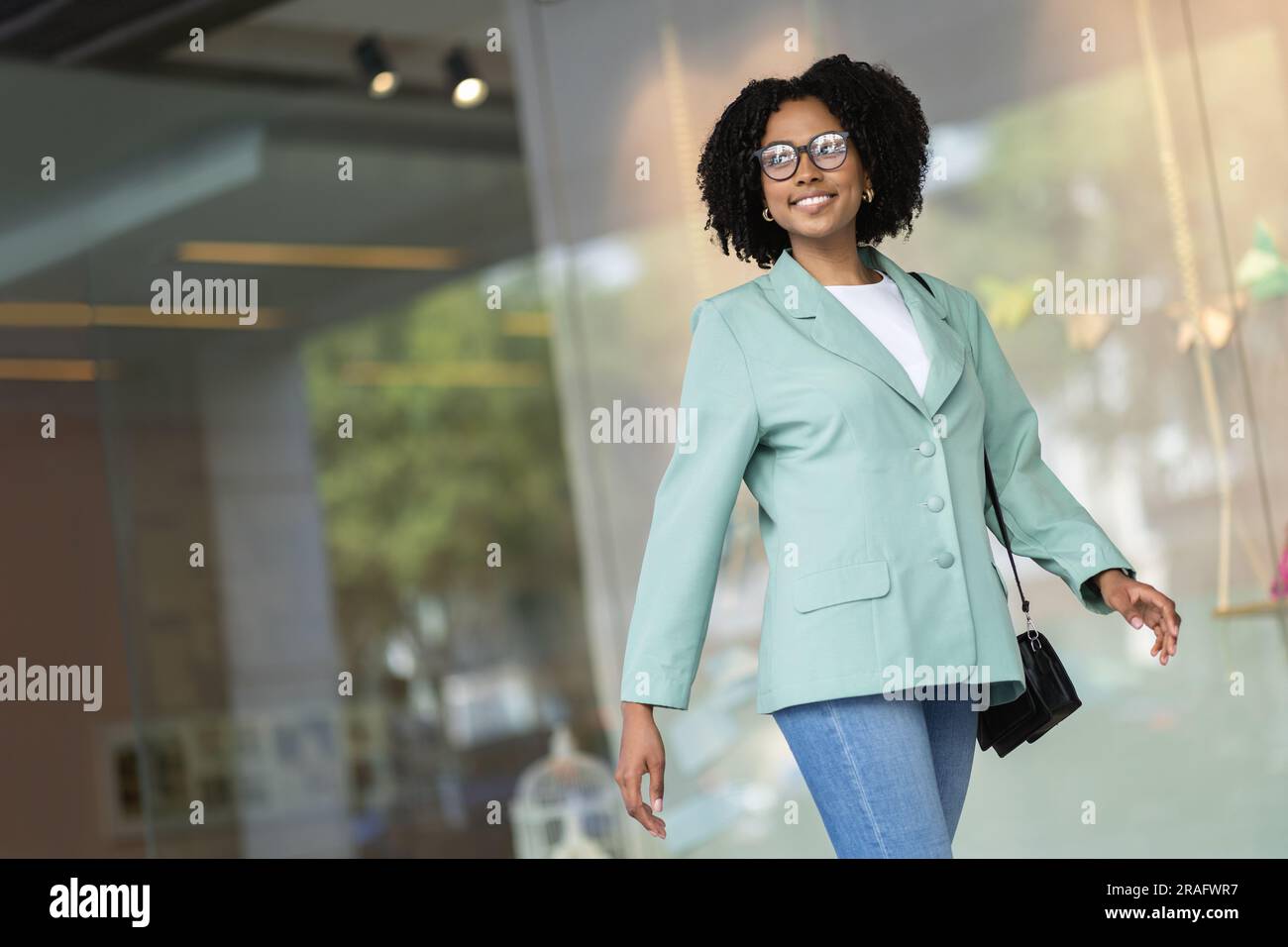 Happy black woman walking street hi-res stock photography and images ...
