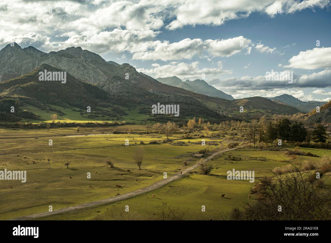 Beautiful mountain landscape with green pastures and an old road in the submerged Buron valley visible due to the low water level of the Riaño reservo Stock Photo