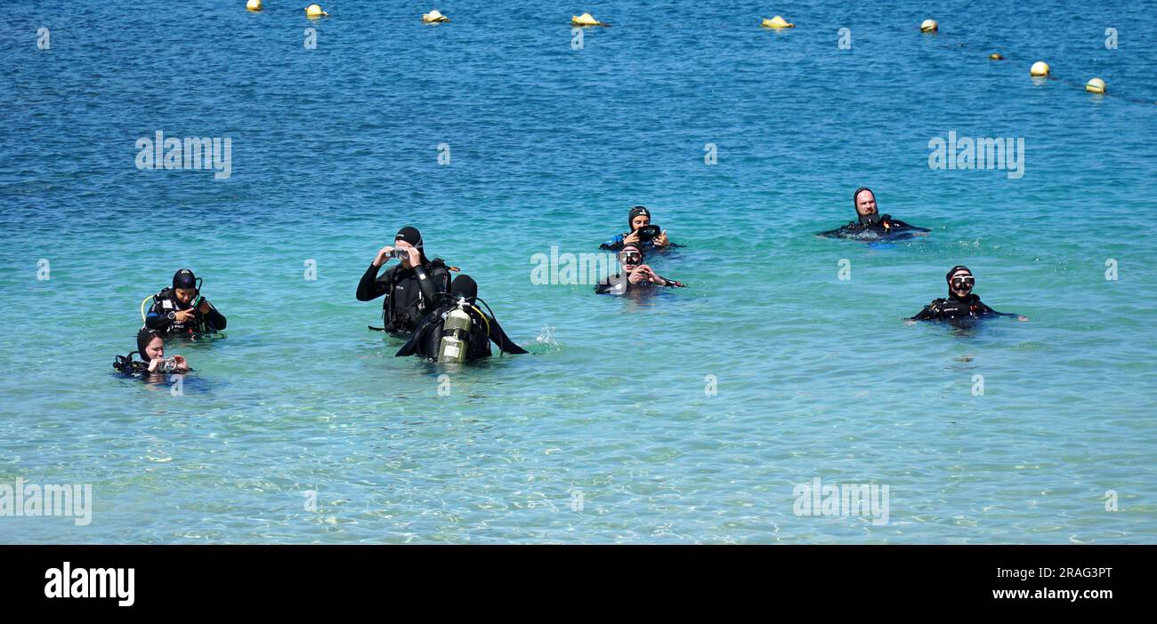 Group of people having a scuba diving lesson. Stock Photo