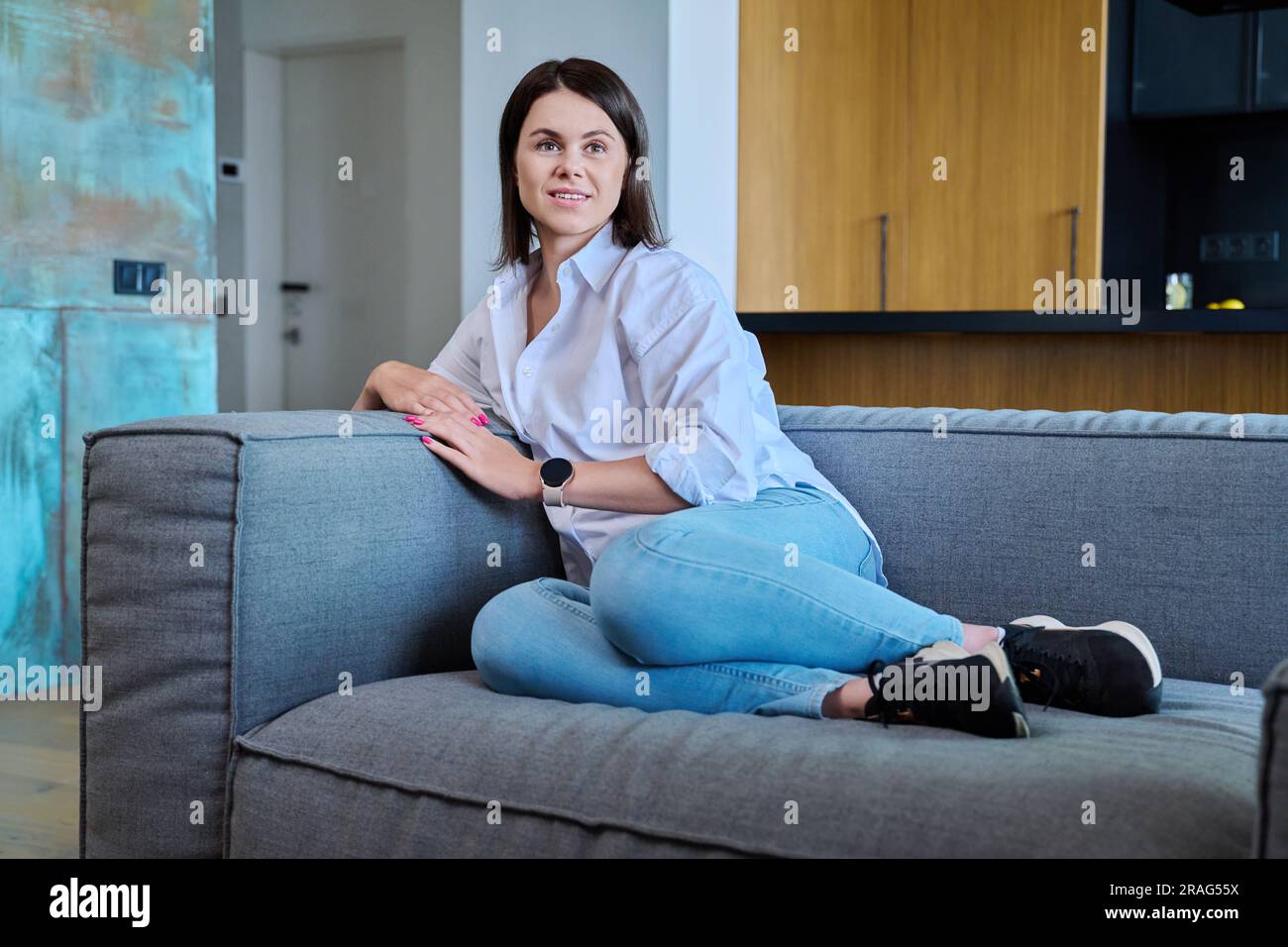 Portrait of attractive young woman in modern home interior Stock Photo ...