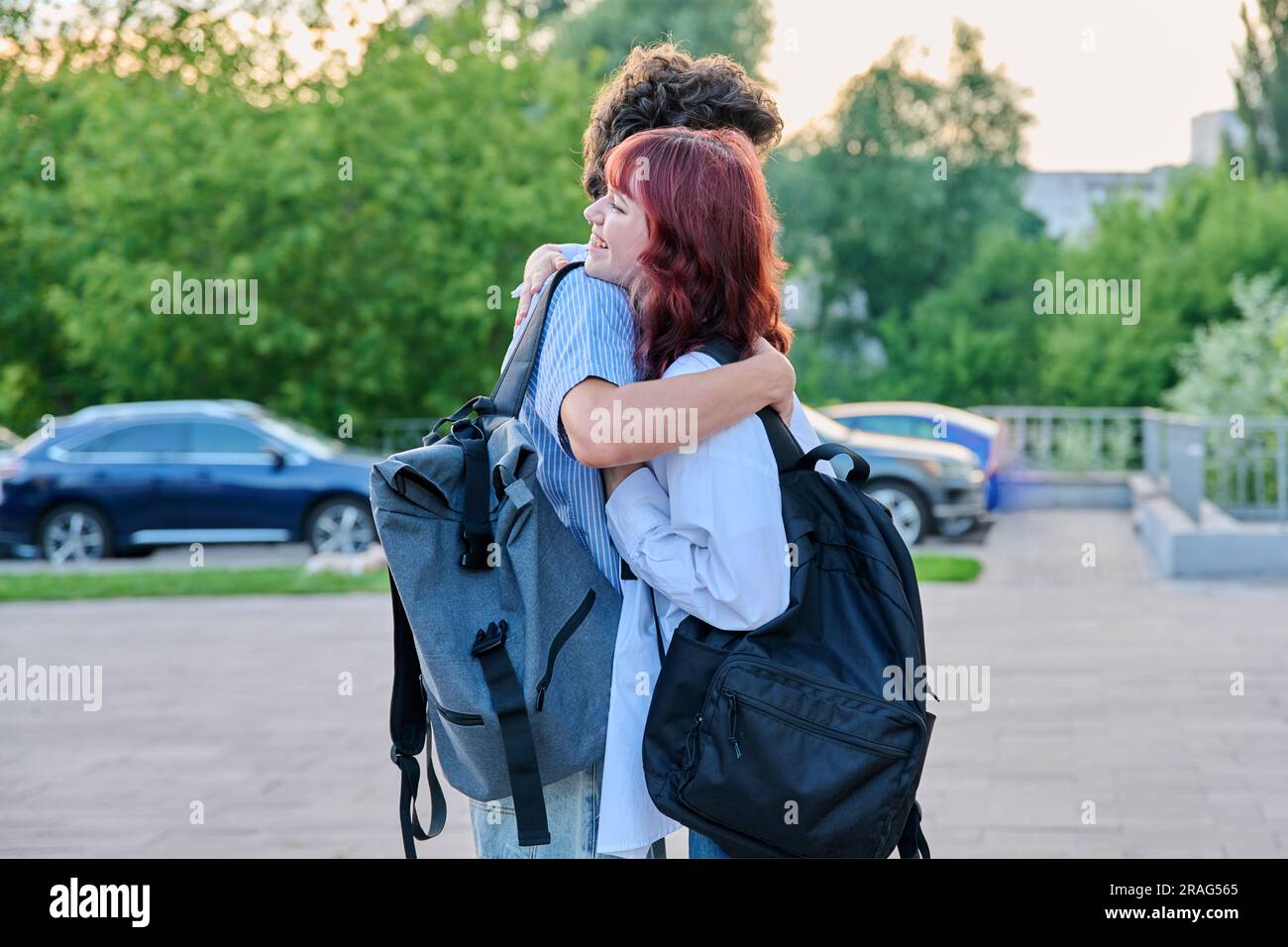 Two college classmates guy and girl with backpacks met outdoor ...