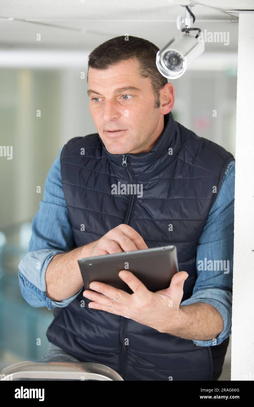 professional cctv technician working with tablet Stock Photo