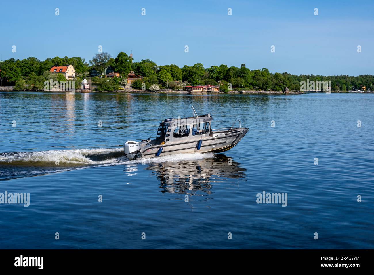 Stockholm, Sweden - June 10 2023: Little speedboat traveling on Malaren lake in Stockholm Stock Photo