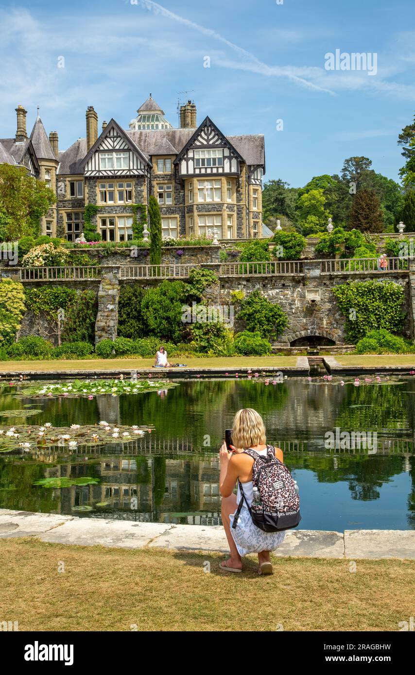 Woman taking photographs photos at the National Trust Bodnant Gardens North Wales Stock Photo