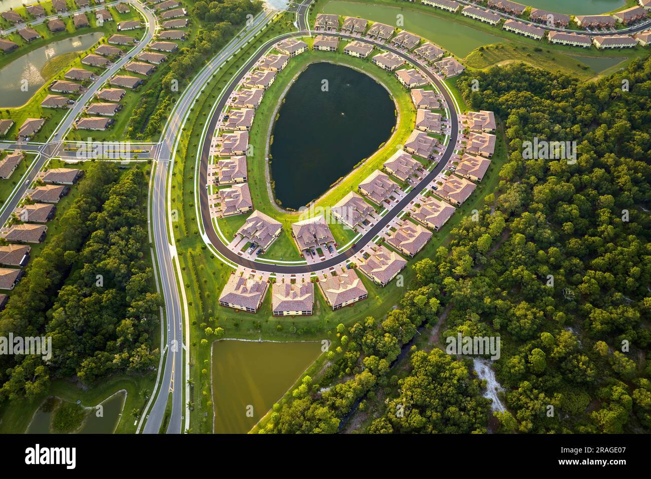 Aerial view of tightly located family houses with retention ponds to