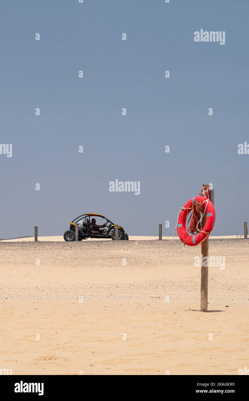 A dune buggy is seen driving during a hot summer day passing through ...