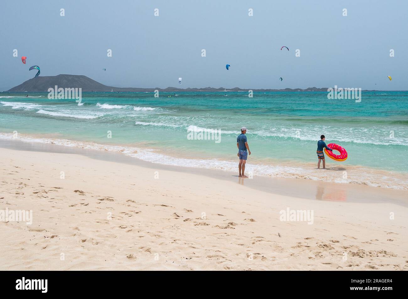 Tourists enjoy a hot summer weather at the crystal clear turquoise ...