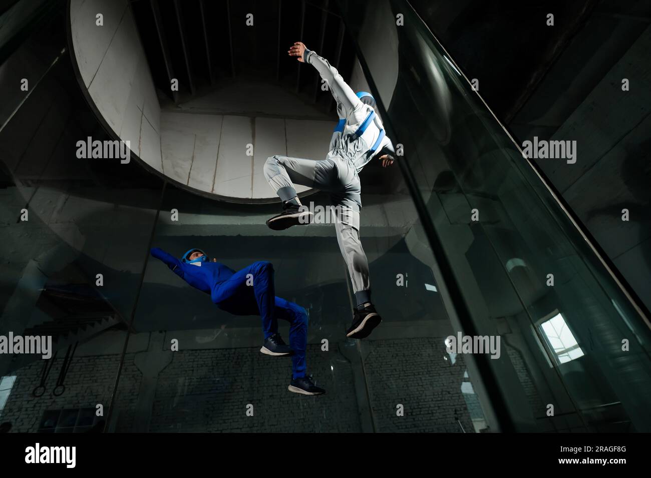 A man and a woman enjoy flying together in a wind tunnel. Free fall ...