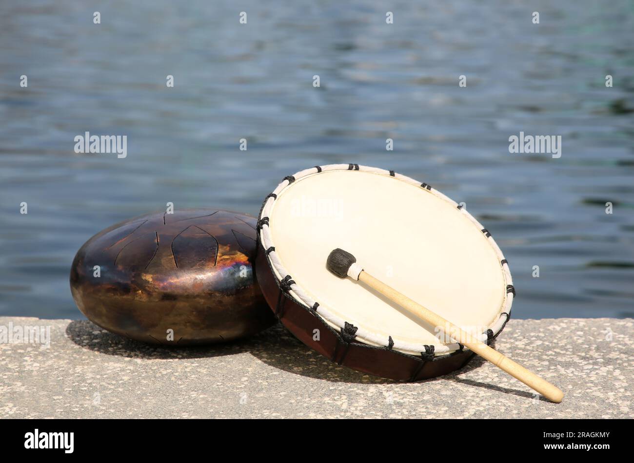 Different drums and drumstick near sea. Percussion musical instruments