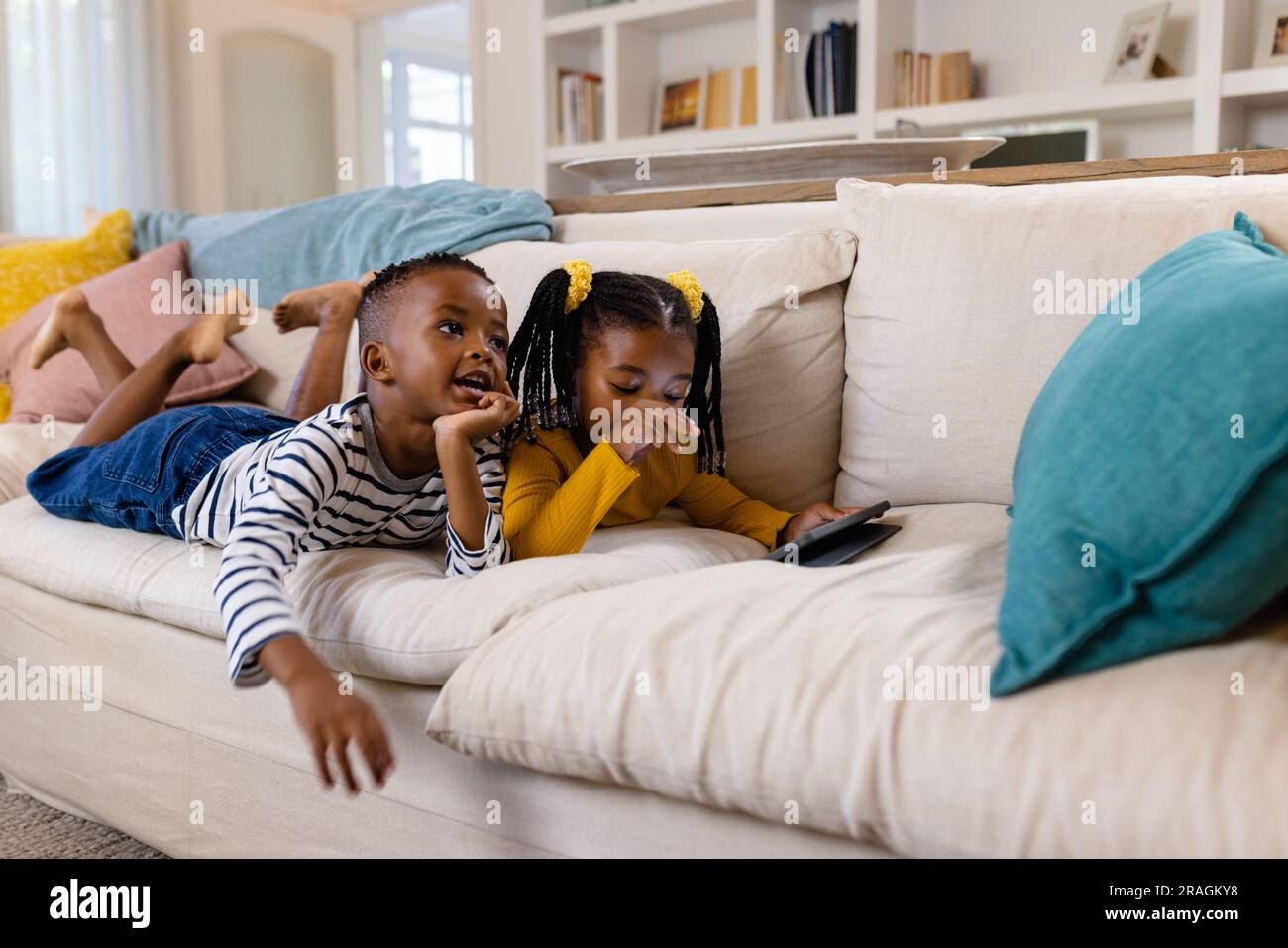 Brother sister lying on sofa hi-res stock photography and images - Alamy