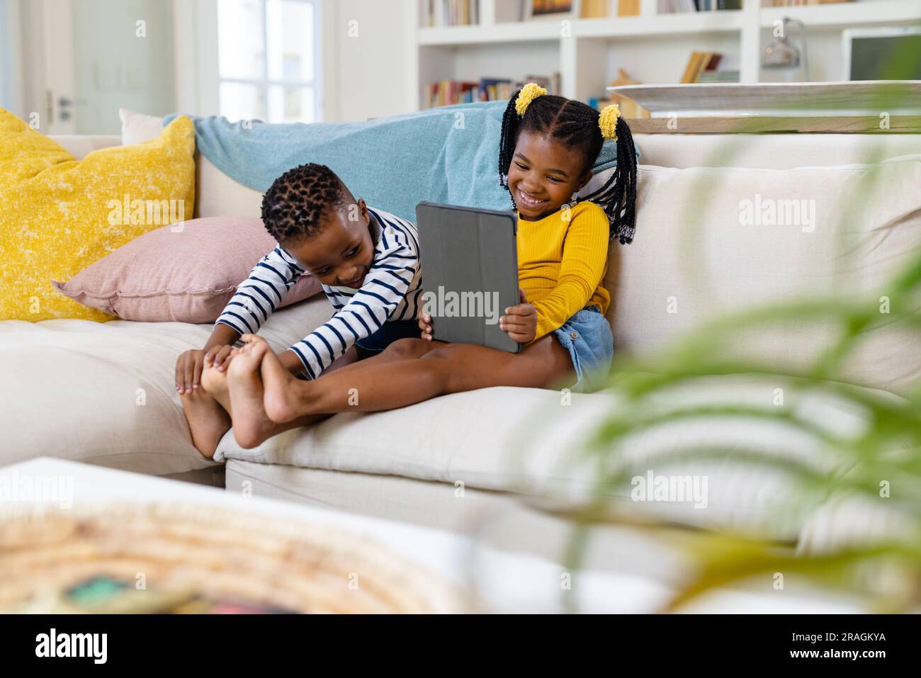 Brother sister sitting on sofa hi-res stock photography and images - Alamy