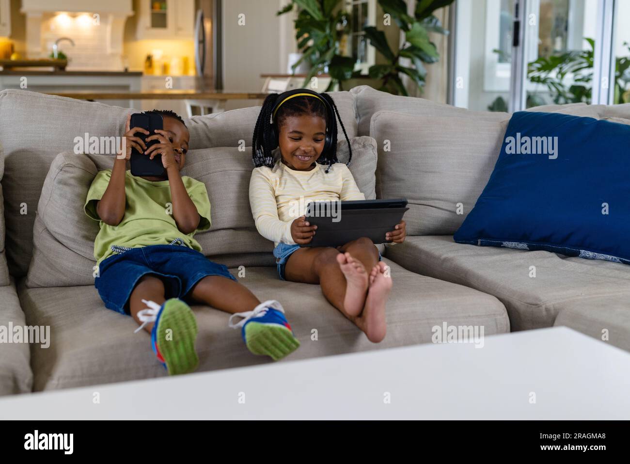 Brother sister sitting on sofa hi-res stock photography and images - Alamy