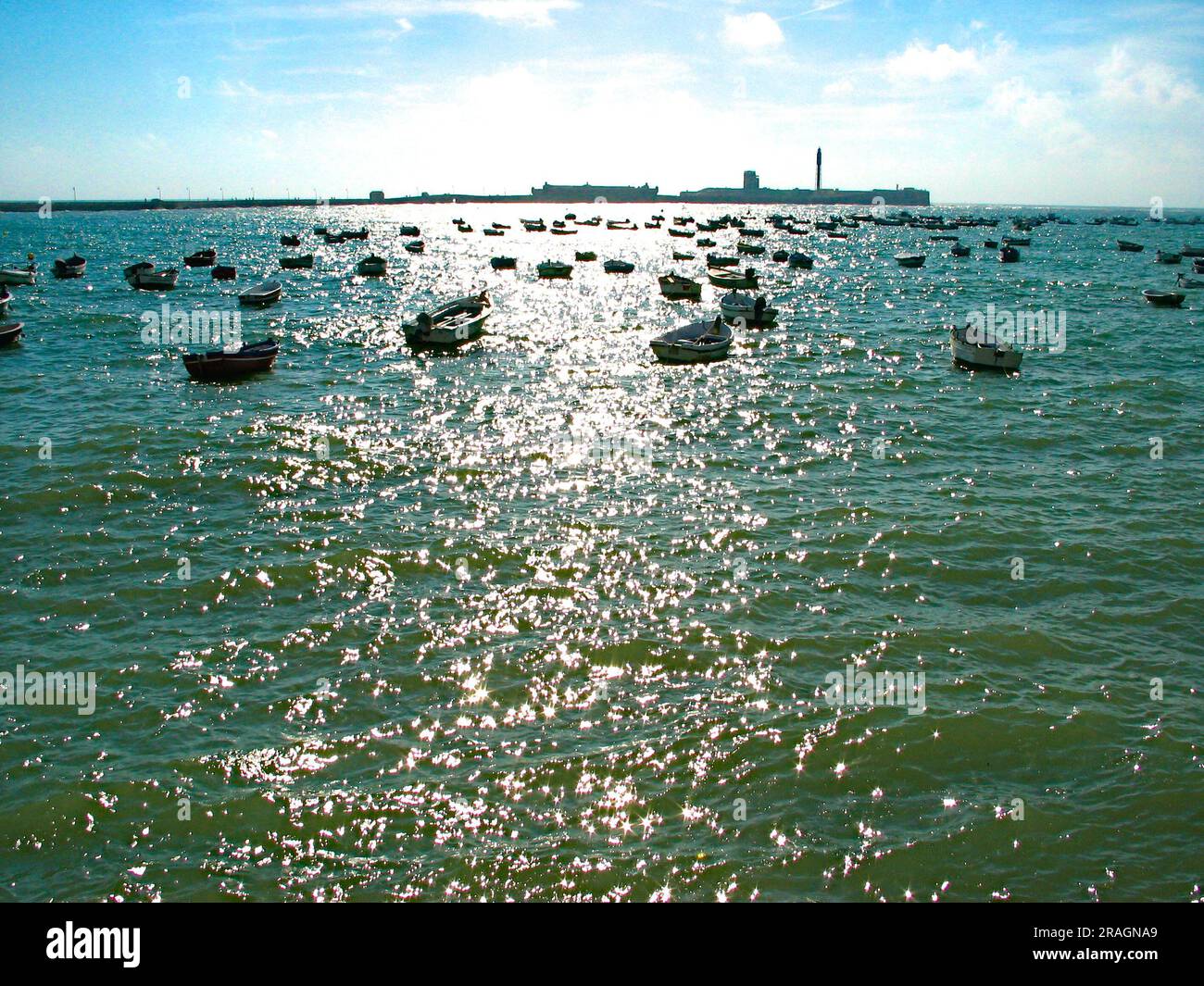 Small fishing boats anchored in sunshine. Stock Photo