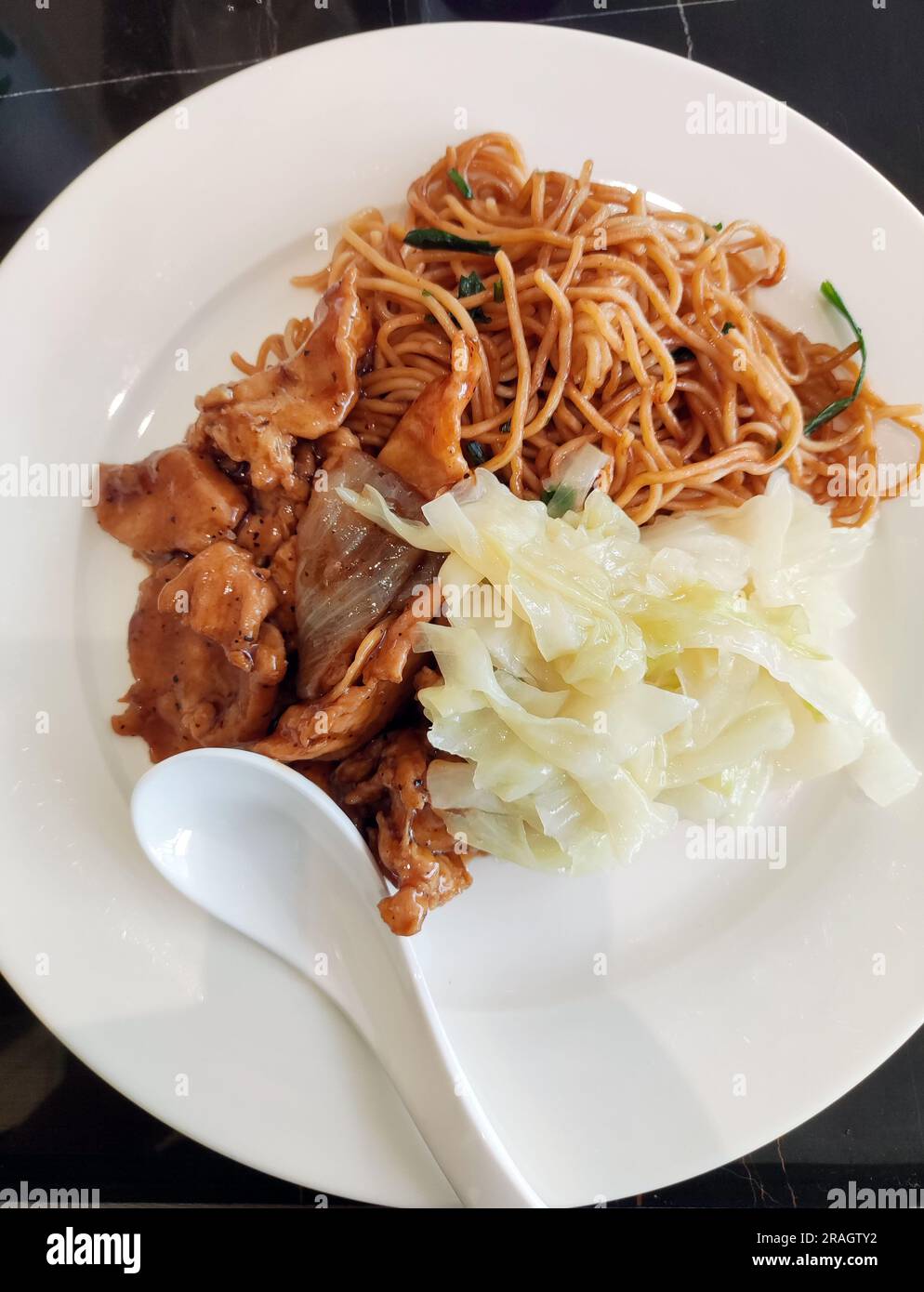 fresh noodles with meat and vegetables in the white plate Stock Photo