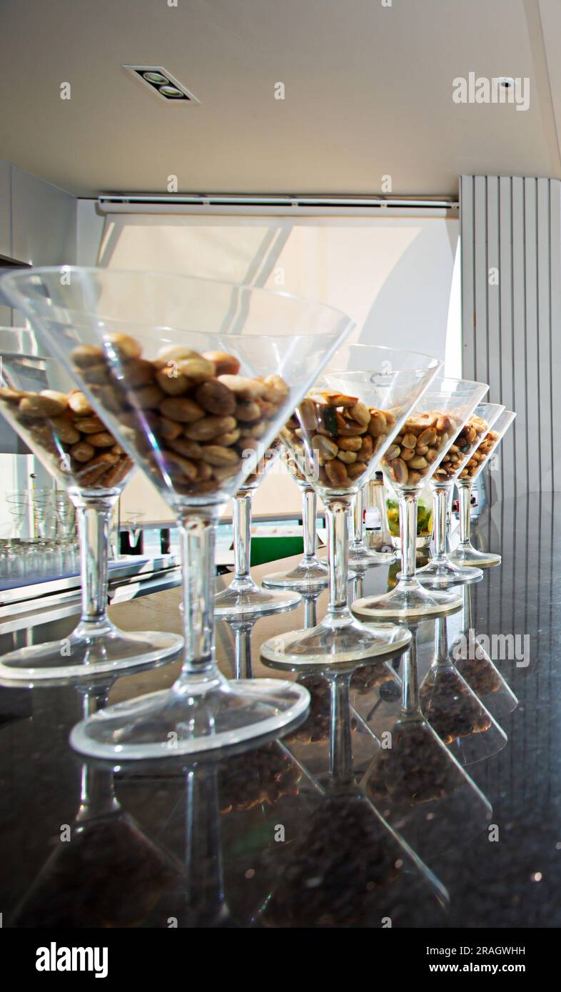 Peanuts in a glass are placed on the bar counter. Stock Photo