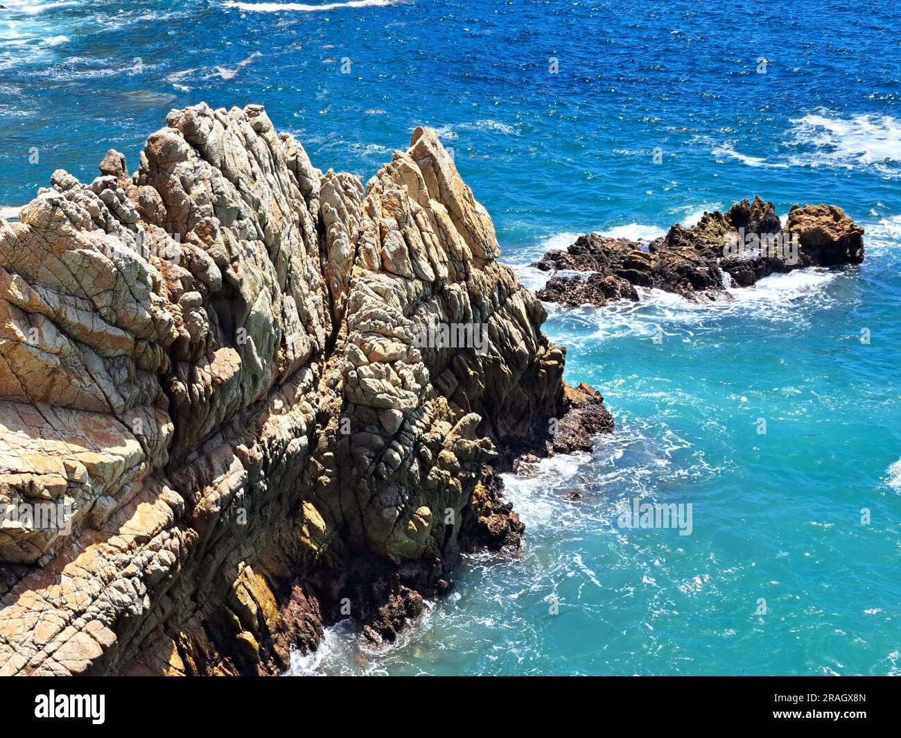 La Quebrada is a cliff with a channel in the port of Acapulco, Guerrero, Mexico where the famous diving is done by young people who climb it Stock Photo