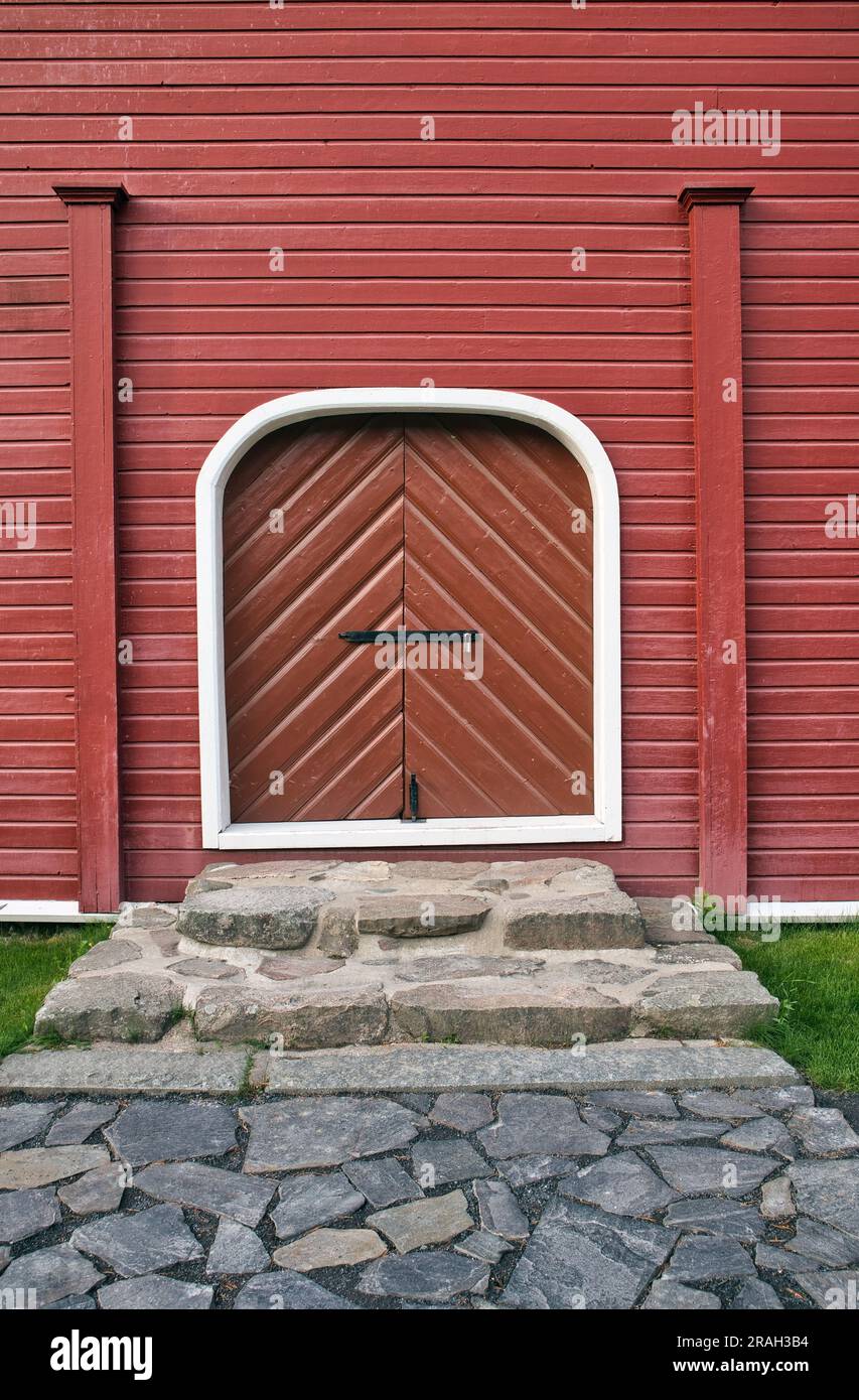 closed woorway on red painted wooden wall outdoors Stock Photo