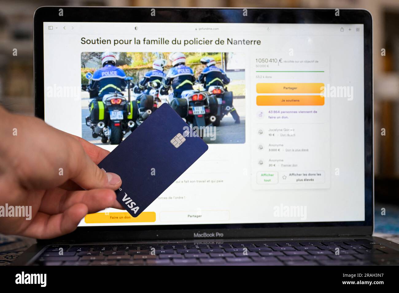 A view of GoFundMe fund to support police officer Florian M. A row has broken out over a collection for the family of the French police officer under investigation for shooting dead a 17-year-old that has topped more than € 1m in donations. A similar collection to help the family of the victim, Nahel M, killed a week ago in Nanterre outside Paris after being stopped by two motorcycle patrol officers, has collected less than € 200,000. The shooting last Tuesday led to a wave of rioting and violence across France and worsened deep political divisions. Protesters clash with riot police in Marseil Stock Photo