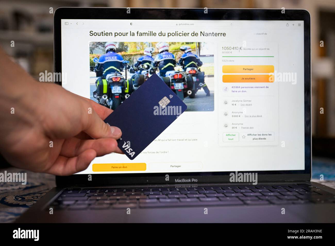 A view of GoFundMe fund to support police officer Florian M. A row has broken out over a collection for the family of the French police officer under investigation for shooting dead a 17-year-old that has topped more than € 1m in donations. A similar collection to help the family of the victim, Nahel M, killed a week ago in Nanterre outside Paris after being stopped by two motorcycle patrol officers, has collected less than € 200,000. The shooting last Tuesday led to a wave of rioting and violence across France and worsened deep political divisions. Protesters clash with riot police in Marseil Stock Photo