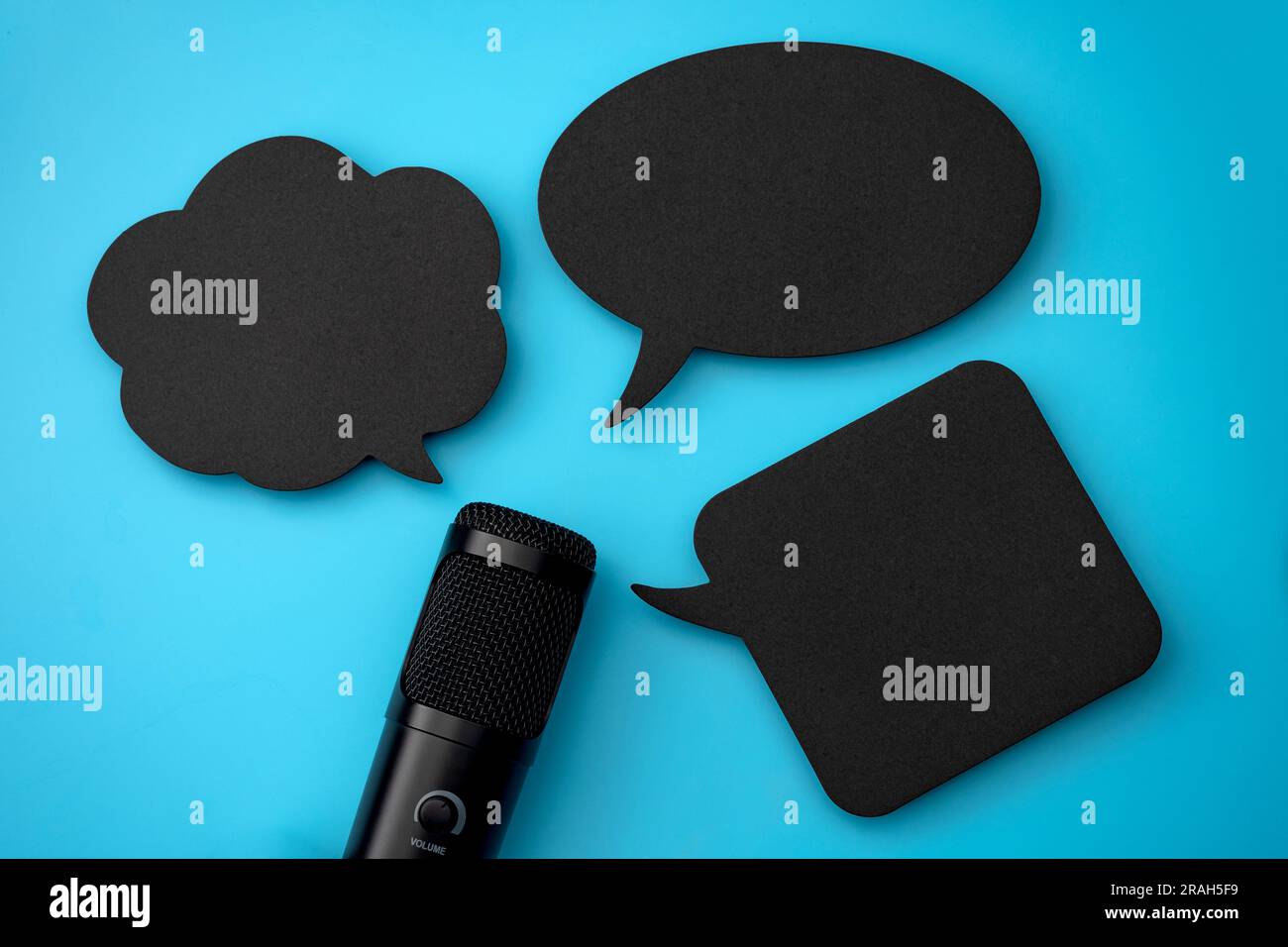 Microphone and Blank Speech Bubbles Isolated on Blue With Copy Space Concept for Audio Media Radio Broadcasting, Chatting in Podcasts, Engaging Audien Stock Photo