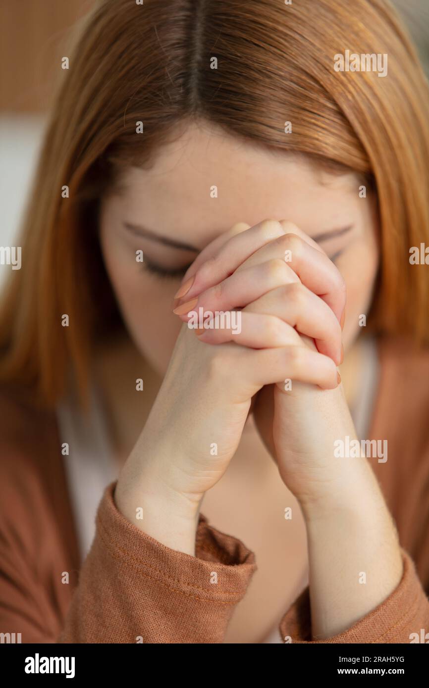 closeup portrait of a young woman praying Stock Photo
