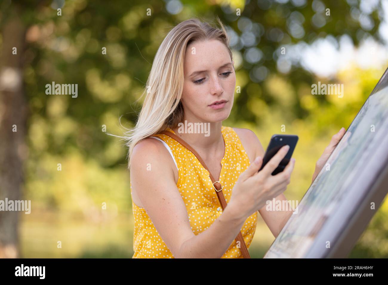 beautiful young woman using smart-phone outdoors Stock Photo
