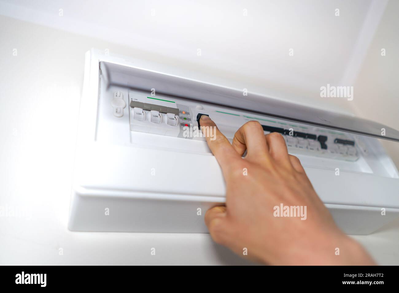 Close up of hand turning onoff the fuse. Fuse box at home. Person