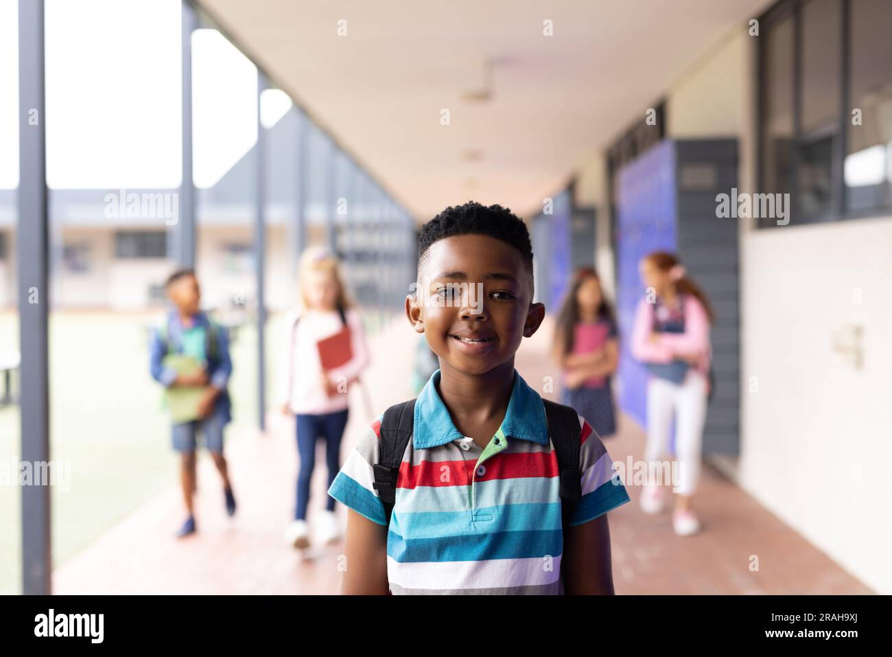 Vertical portrait of smiling african american boy in elementary school ...