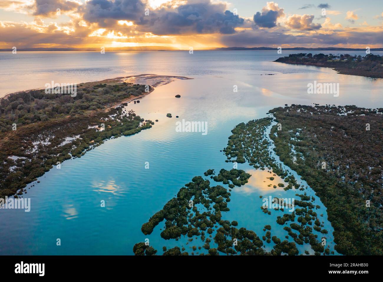 Aerial view of coastal wetlands leading out to the sea under a dramatic sunrise  at Rhyll on Phillip Island in Victoria, Australia Stock Photo