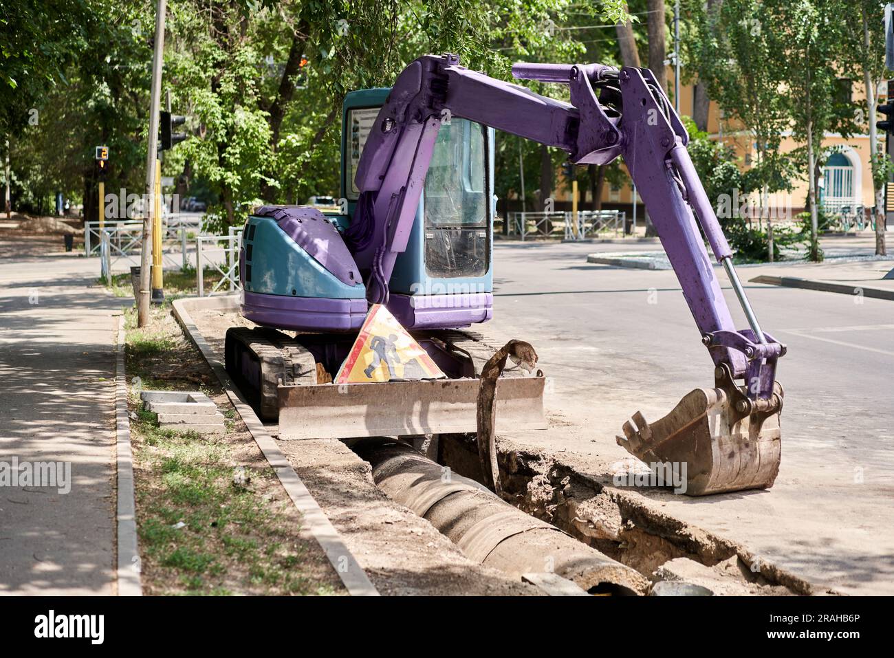Big jackhammer drill drilling road.Heavy machinery crushing asphalt for