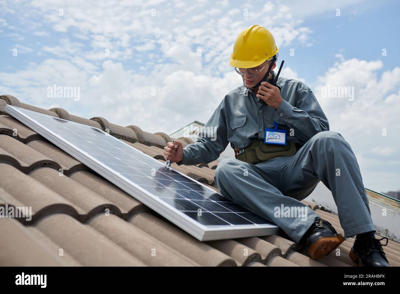 Talking Panel In House Contractor installing solar panel and using with walkie-talking Stock ...