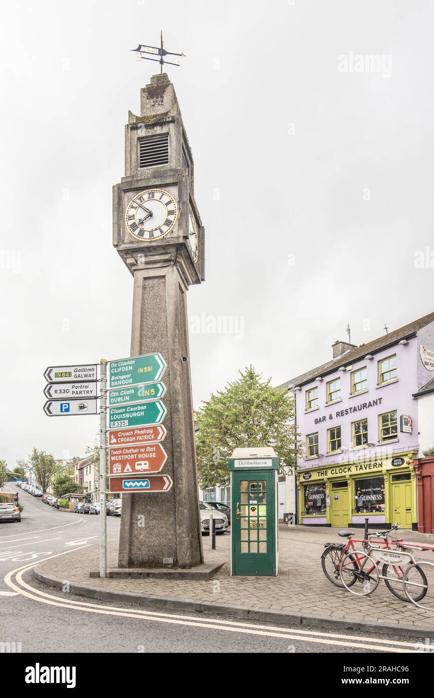 The Clock Tavern, the defibrillator phone box, road signage and the Westport Town Clock at Westport County Mayo, Irleand. Stock Photo