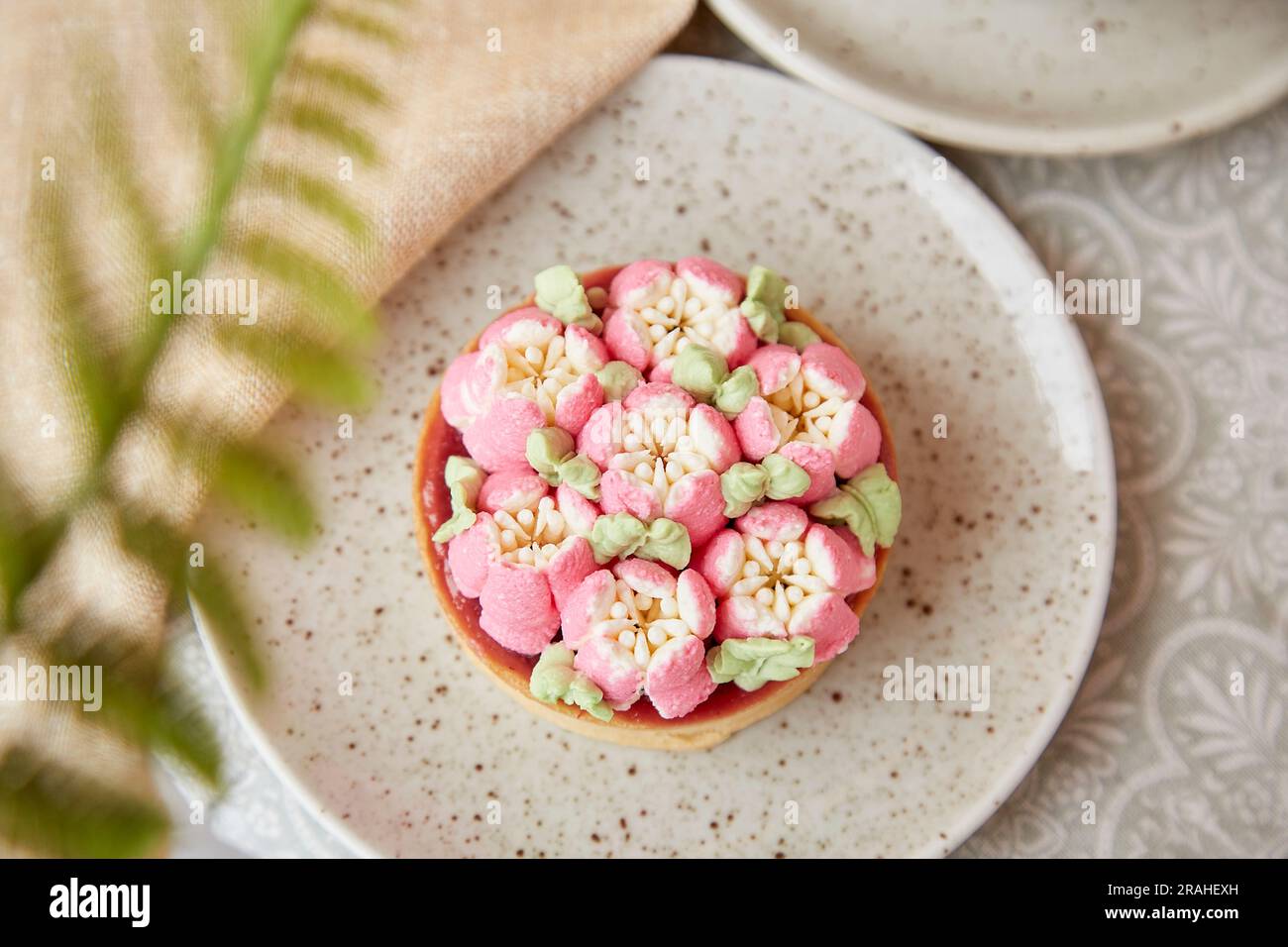 Trendy french tart with flowers. Pink, surreal, escapism flowers cake. Three- dimensional layers background. Stock Photo